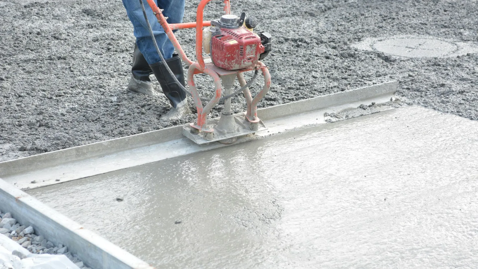 ADU concrete pad being finished with a power screed